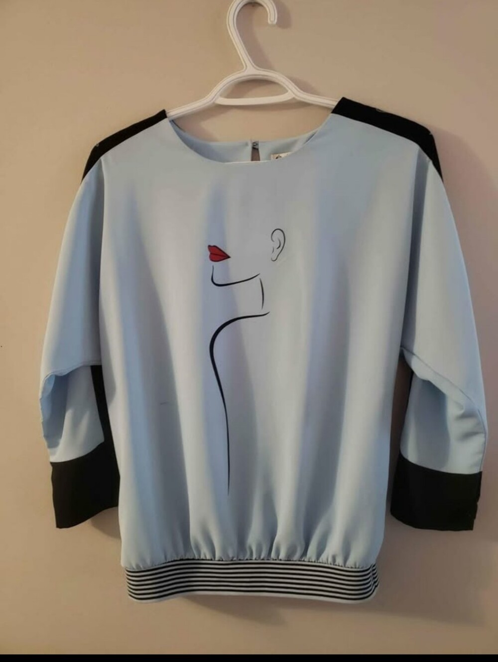 Light Blue Graphic Pullover Top with Black Accents